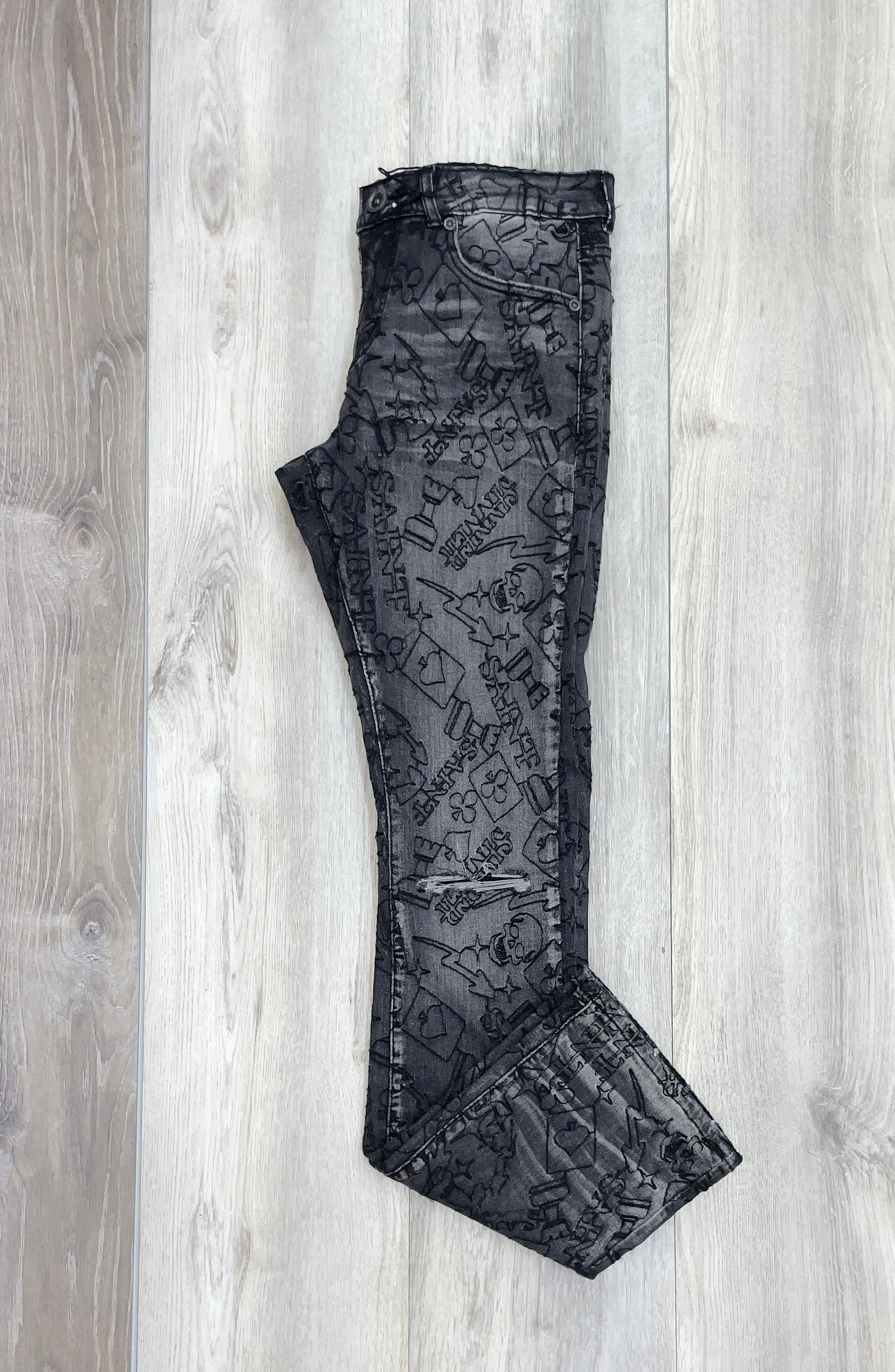 BLACK EMBOSSED GRAPHIC JEANS